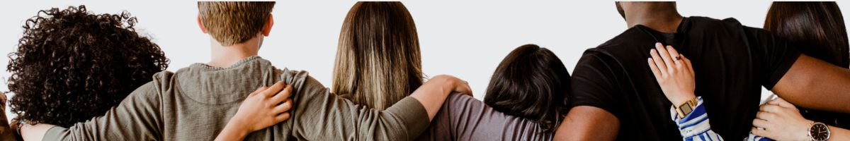 Four women and two men standing next to each other with their arms around each other's backs.