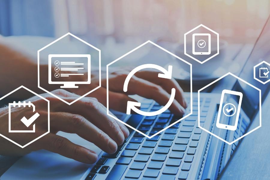 A person's hands are typing on a laptop with 6 white hectogon elements. 