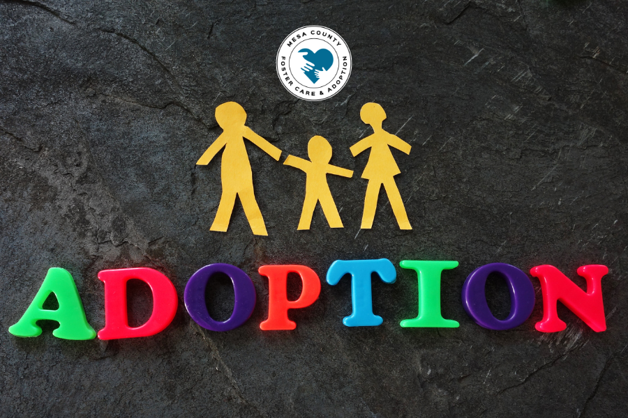 Adoption in block letters with paper cut-out family and DHS Foster Adopt logo