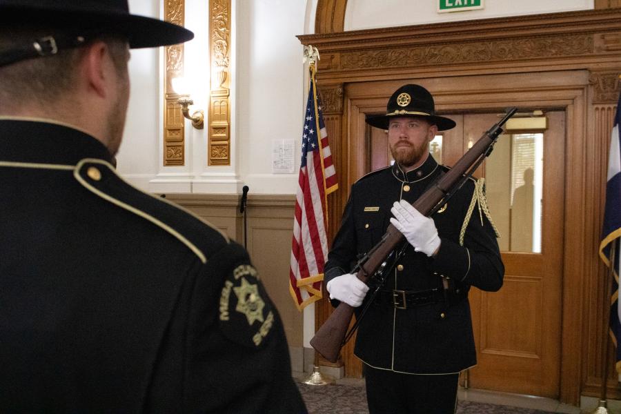 The Mesa County Sheriff’s Office and Grand Junction Police Department joint Honor Guard member stands facing another member of the Honor Guard. 