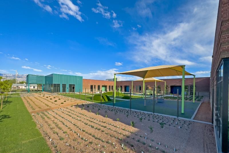 Green and tan outdoor canopy and fresh landscaping. 