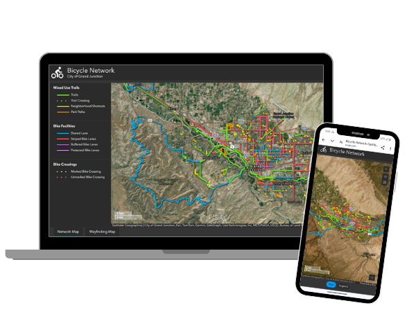 Image of a monitor and cellphone showing the wayfinding website for bike trails around the Grand Junction area.