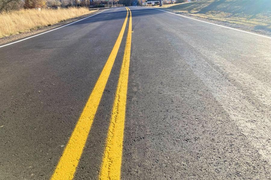 Black road with two yellow stripes in the middle.