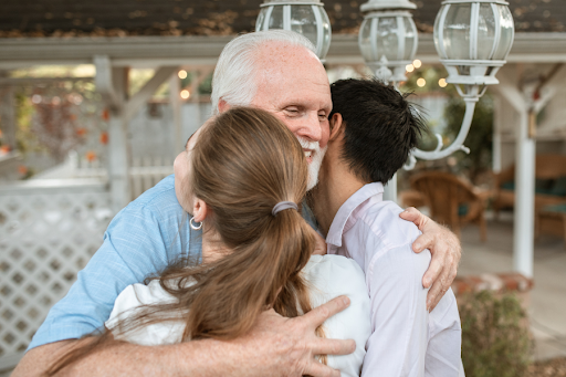 Kinship grandparent embracing two children.