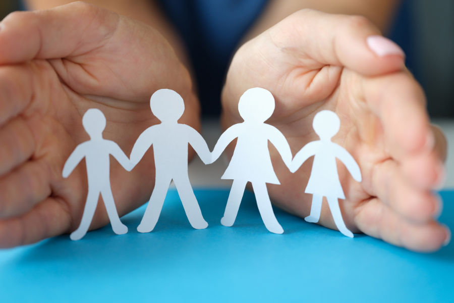 stick figure family held by human hands