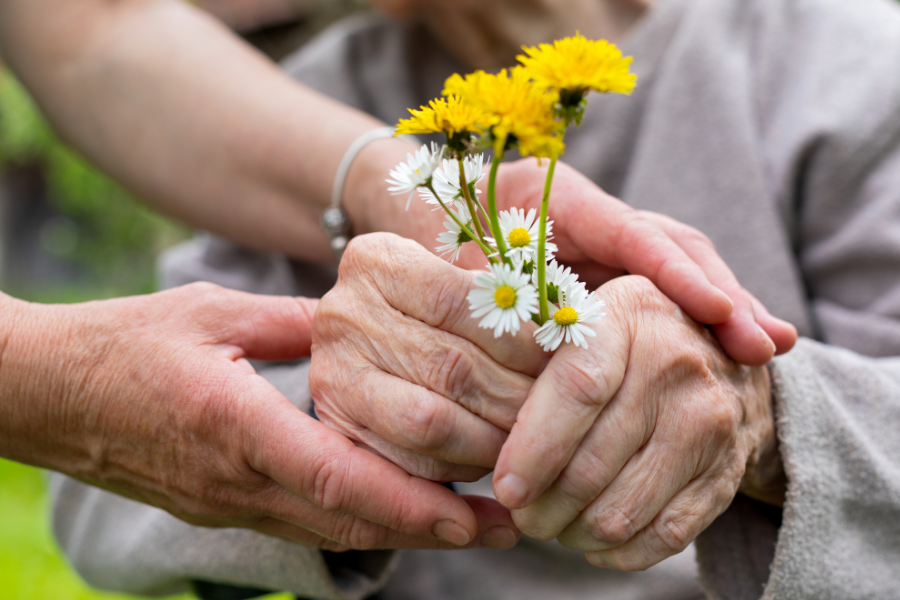 Elder holding flowers