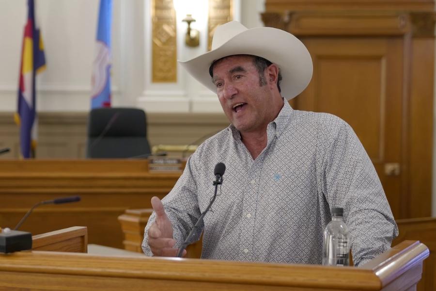 A man standing at a lectern. 