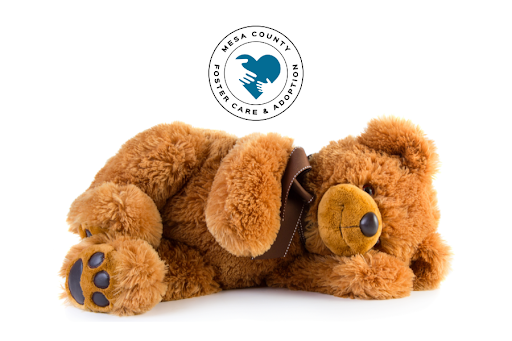 Stuffed teddy bear with foster adopt mesa county logo