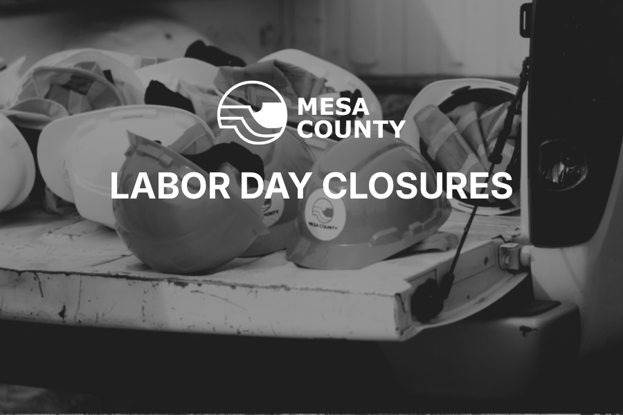 Black and white photo of hard hats in the back of a pickup truck with a white Mesa County logo graphic. Text on the photo says "labor day closures."